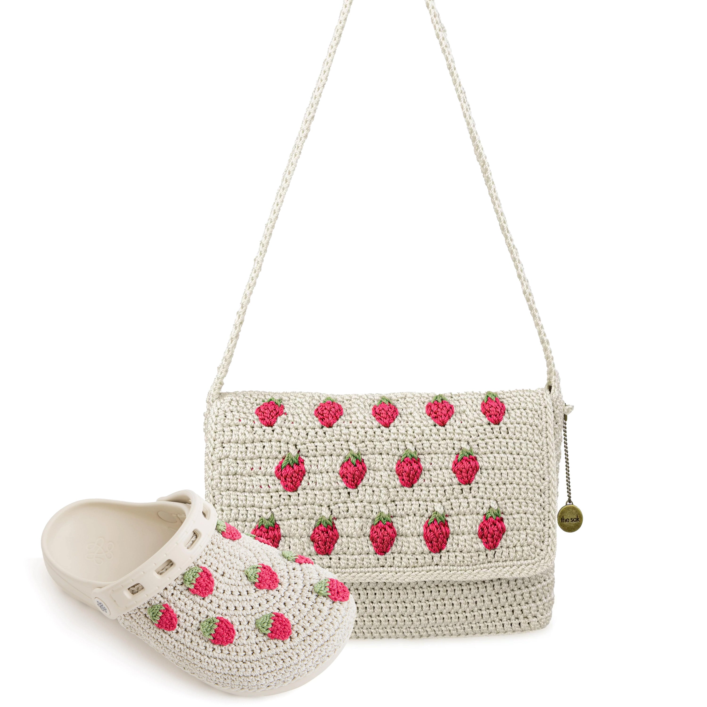 Cream knit shoulder bag with raspberry pattern and matching cream clog with raspberry embellishments.