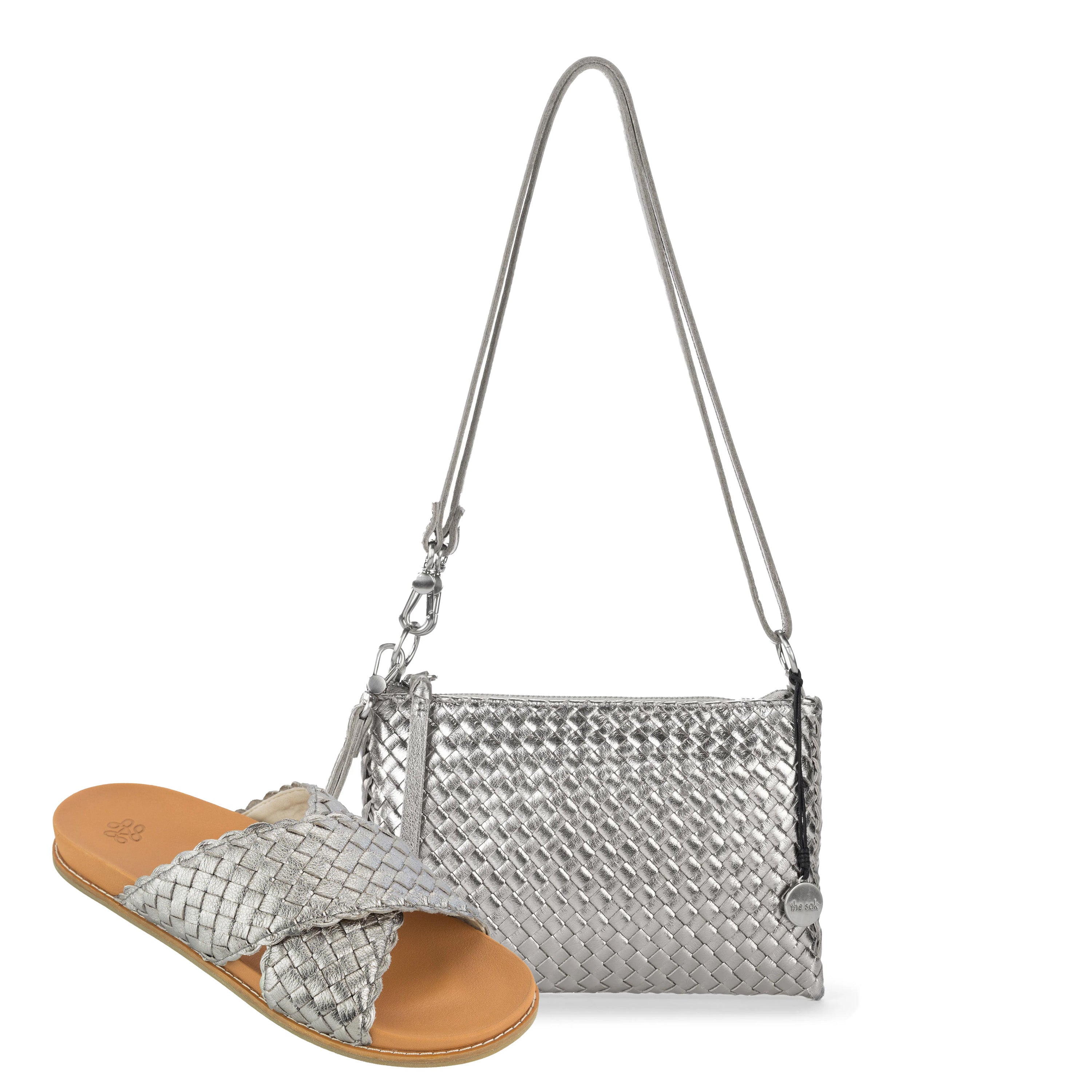 Silver woven wristlet with shoulder strap and matching silver woven sandal with tan leather sole.